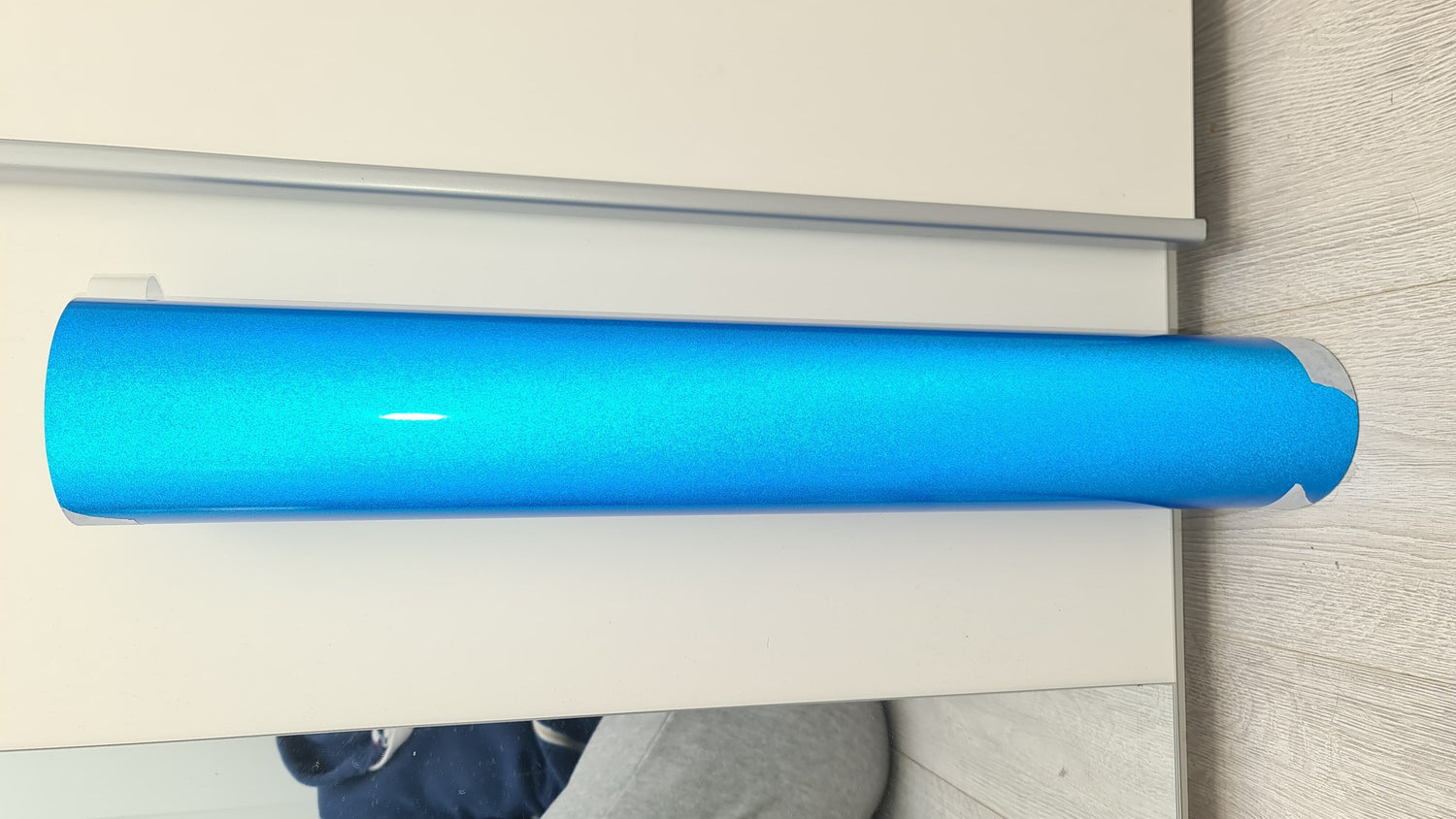 SuperWrappz light blue reflective vinyl material, alternate angle showing reflective sheen.