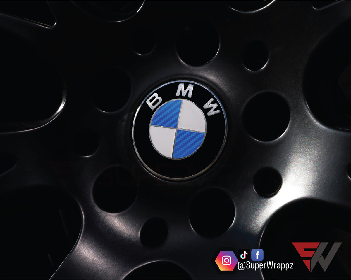 Half Blue Carbon BMW badge overlay on an alloy wheel centre cap, close-up
