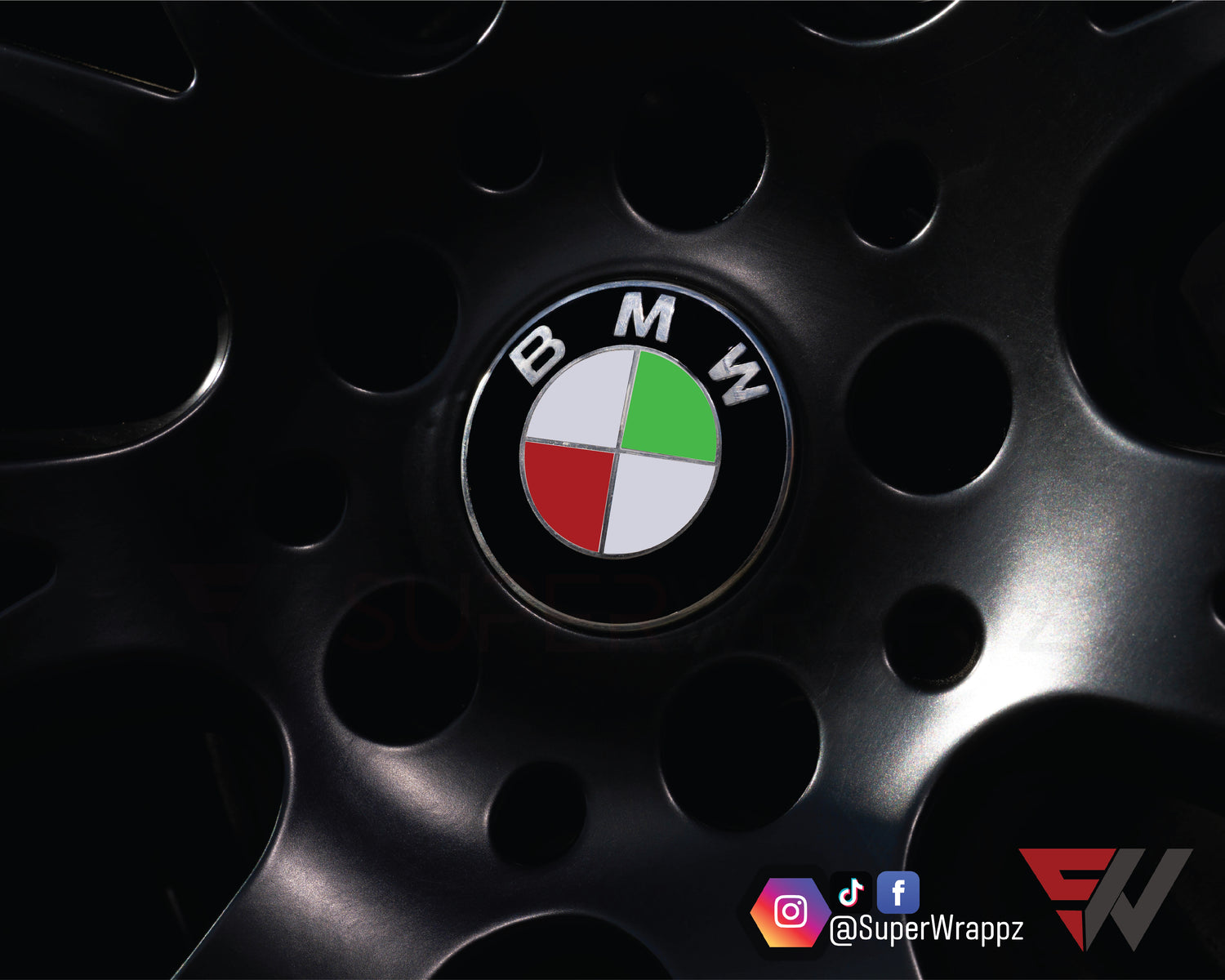 Italy & Hungary Flag BMW badge overlay on an alloy wheel centre cap, close-up