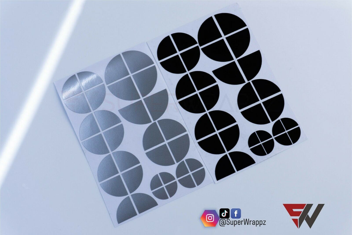 Black & Silver Gloss BMW badge overlay, shown uncut on its adhesive backing sheet before application