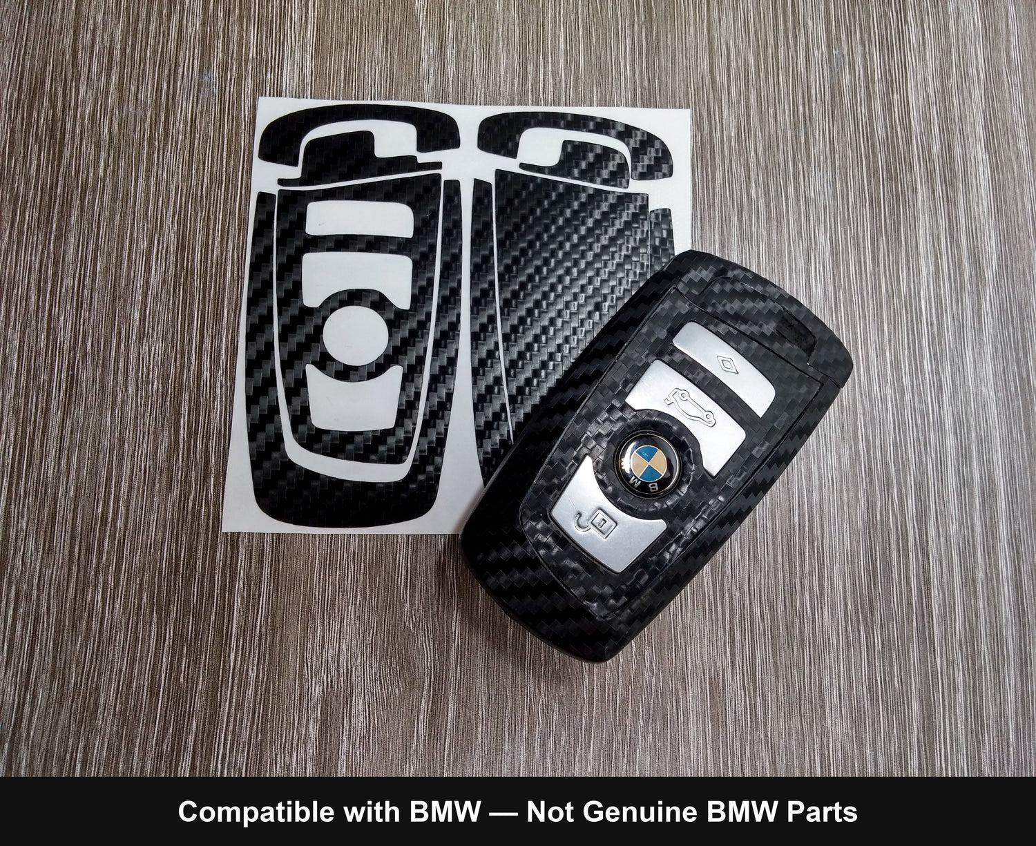 Carbon LATCH key wrap kit beside a wrapped BMW F-series blade fob — precision-cut pieces on the backing sheet.