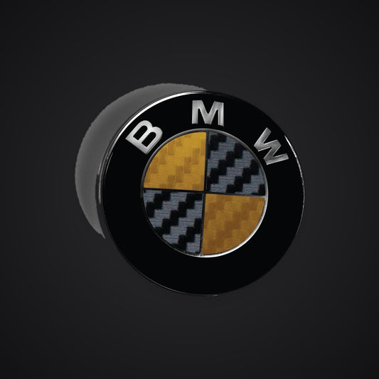 Black Gold Carbon BMW badge overlay — SuperWrappz hero. Compatible with BMW — Not Genuine BMW Parts.
