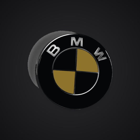 Black gold gloss BMW badge overlay — SuperWrappz hero. Compatible with BMW — Not Genuine BMW Parts.