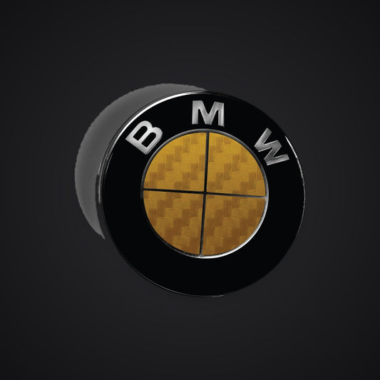 Full Gold Carbon BMW badge overlay — SuperWrappz hero. Compatible with BMW — Not Genuine BMW Parts.