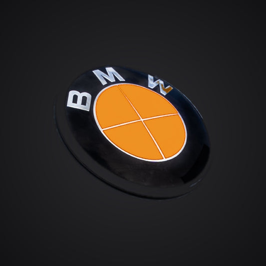 Full Orange Fluorescent BMW badge overlay — SuperWrappz hero. Compatible with BMW — Not Genuine BMW Parts.