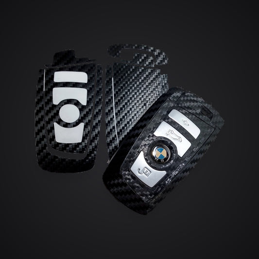 SuperWrappz key wrap in carbon — pre-cut kit and a wrapped F-series fob. Compatible with BMW — Not Genuine BMW Parts.
