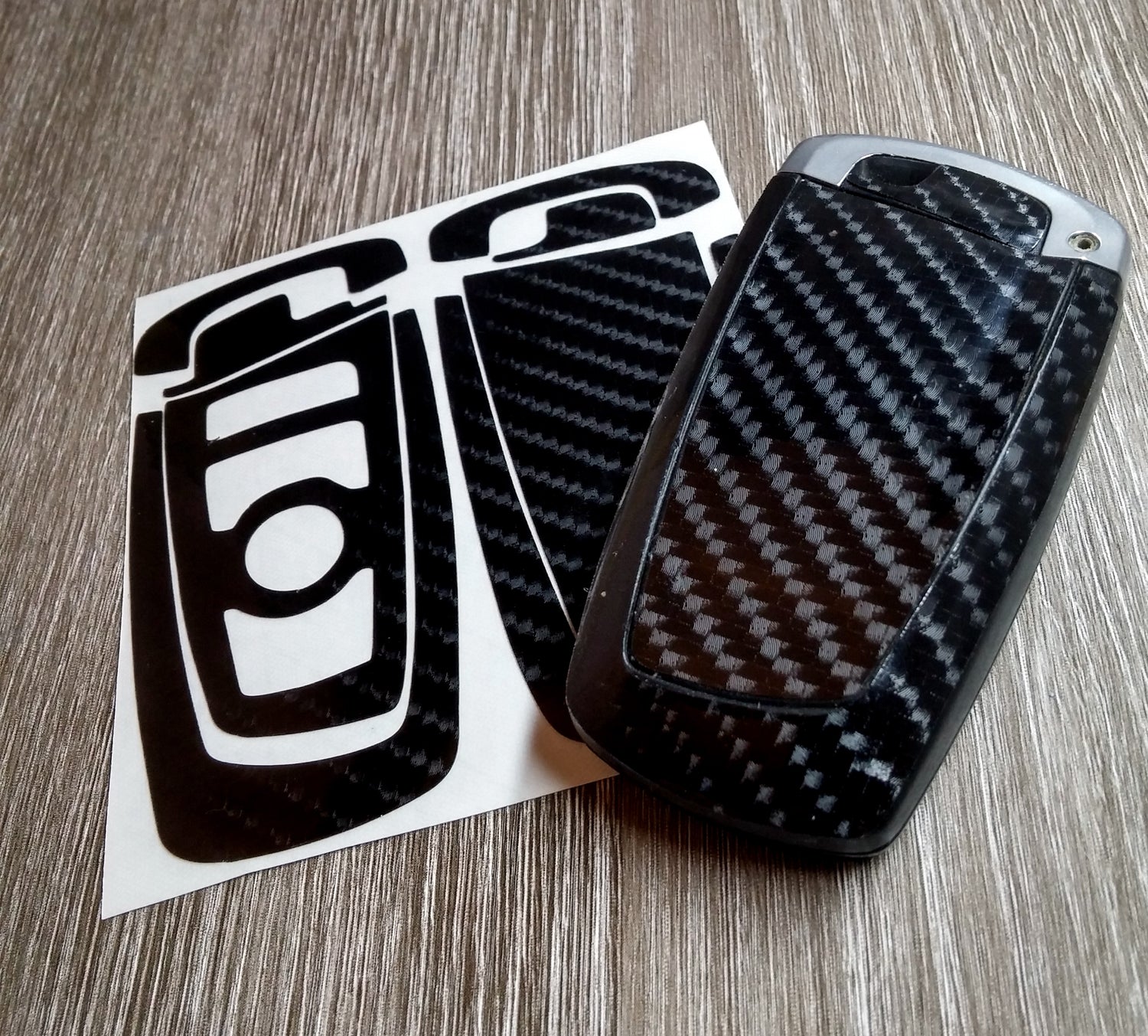 Gloss black LATCH key wrap kit with a wrapped BMW F-series blade key fob.