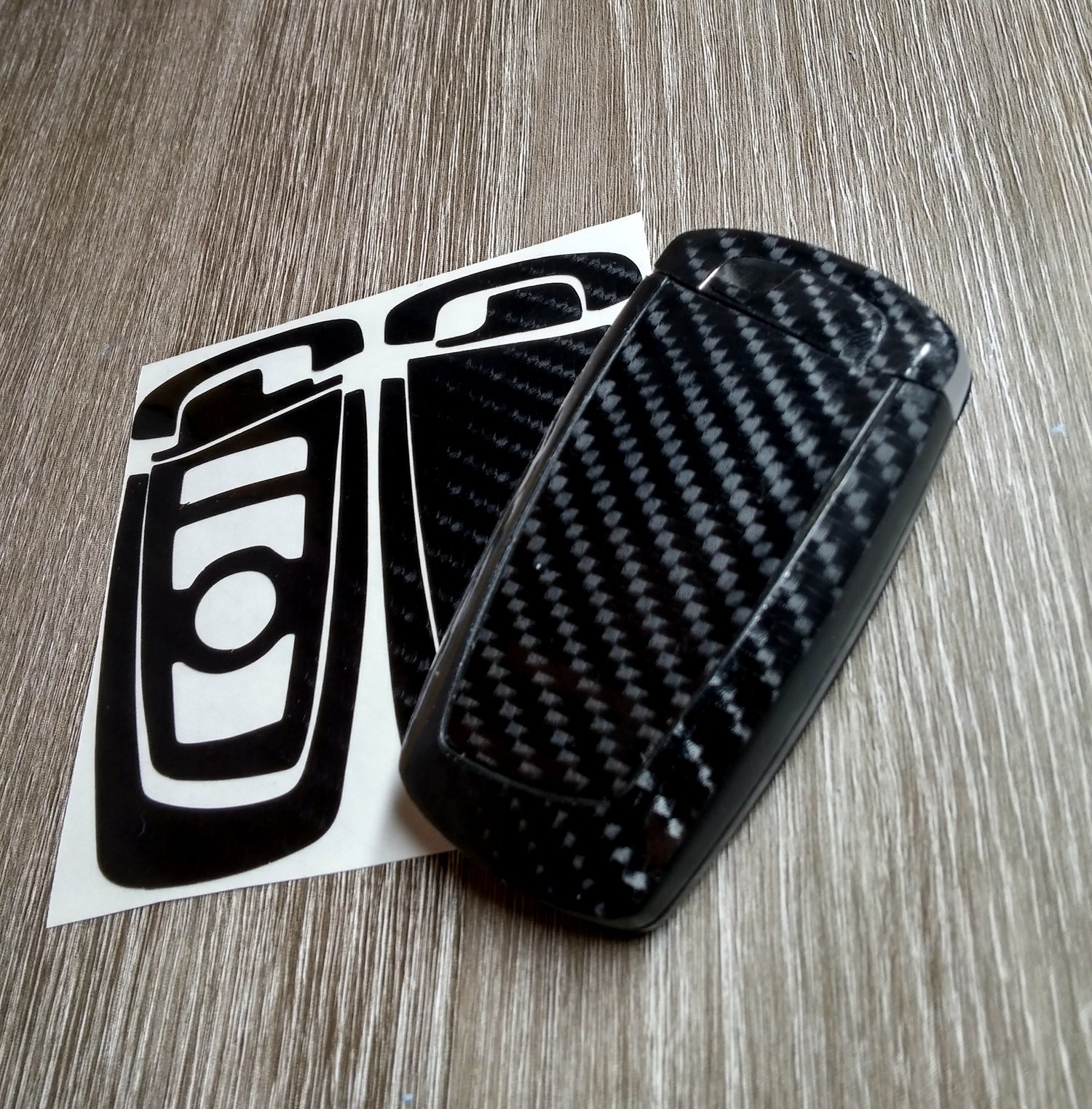 BMW F-series blade key fob fully wrapped in SuperWrappz gloss black vinyl.