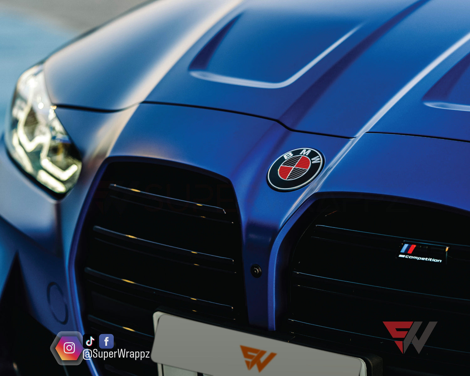 Black and Red Carbon V2 BMW badge overlay by SuperWrappz for F40/G20/G30 2017-plus BMWs, aftermarket cast vinyl