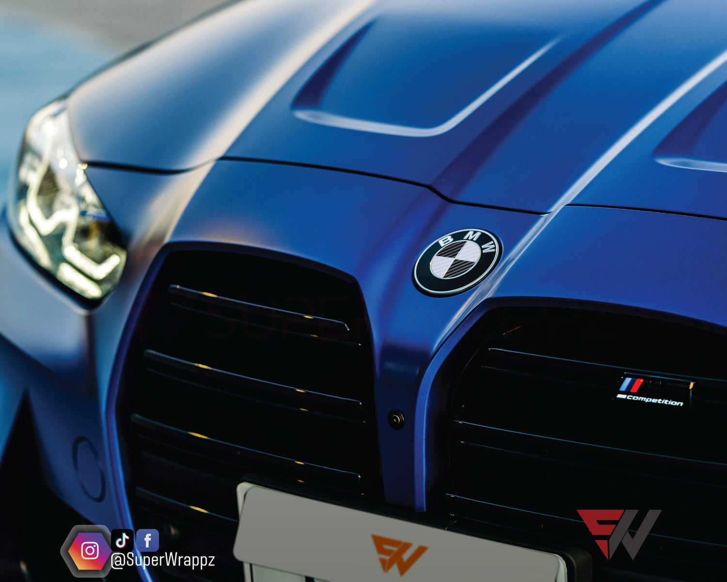 Black and White Carbon V2 BMW badge overlay by SuperWrappz for F40/G20/G30 2017-plus BMWs, aftermarket cast vinyl