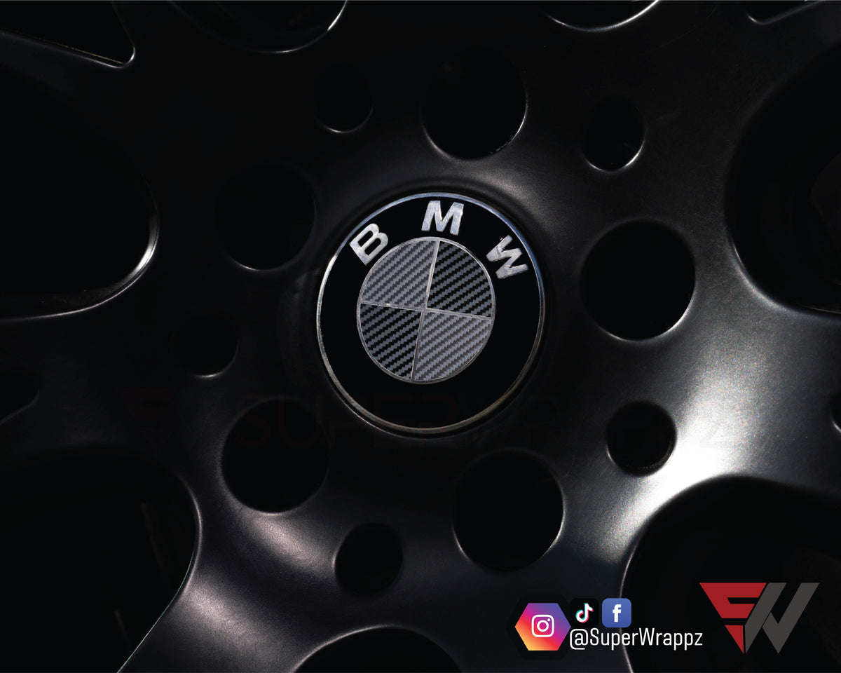 Black & Anthracite Carbon BMW badge overlay applied to an alloy wheel centre cap, close-up