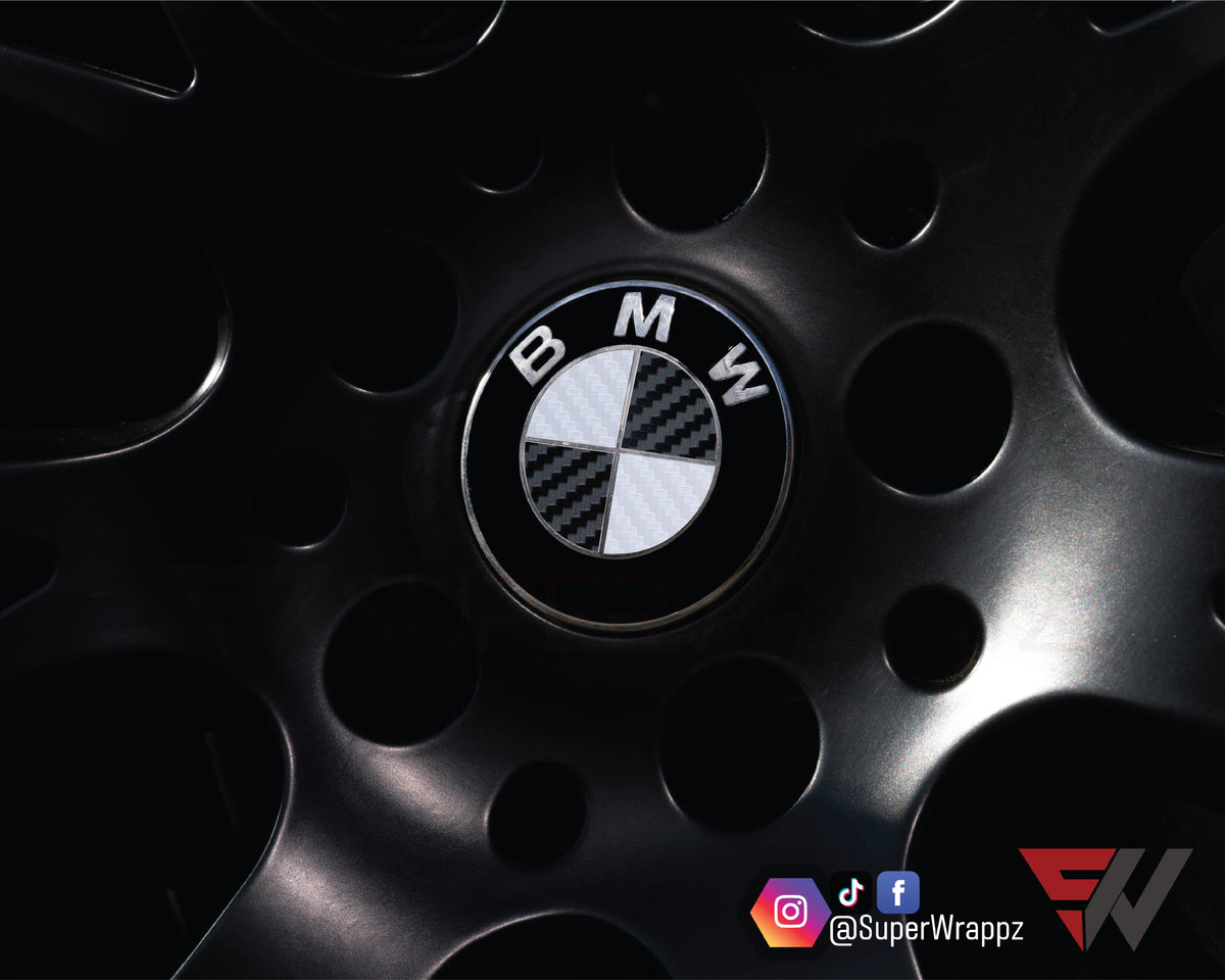 White & Black Carbon BMW badge overlay applied to an alloy wheel centre cap, close-up