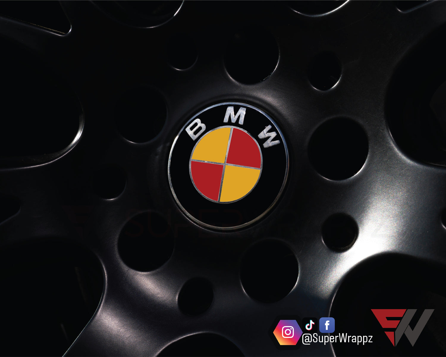 Spain Flag BMW badge overlay on an alloy wheel centre cap, close-up