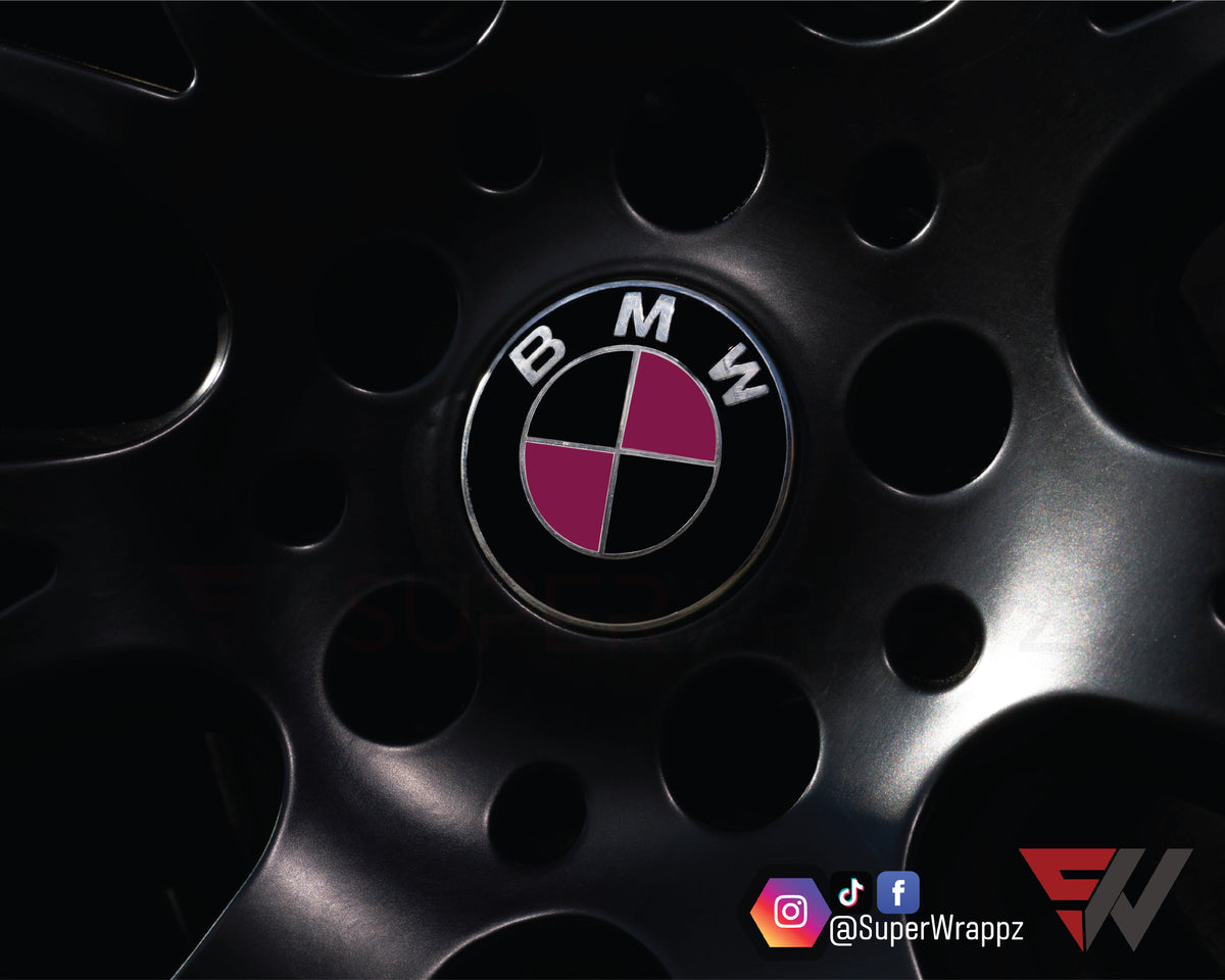 Black & Pink Fuchsia Gloss BMW badge overlay applied to an alloy wheel centre cap, close-up