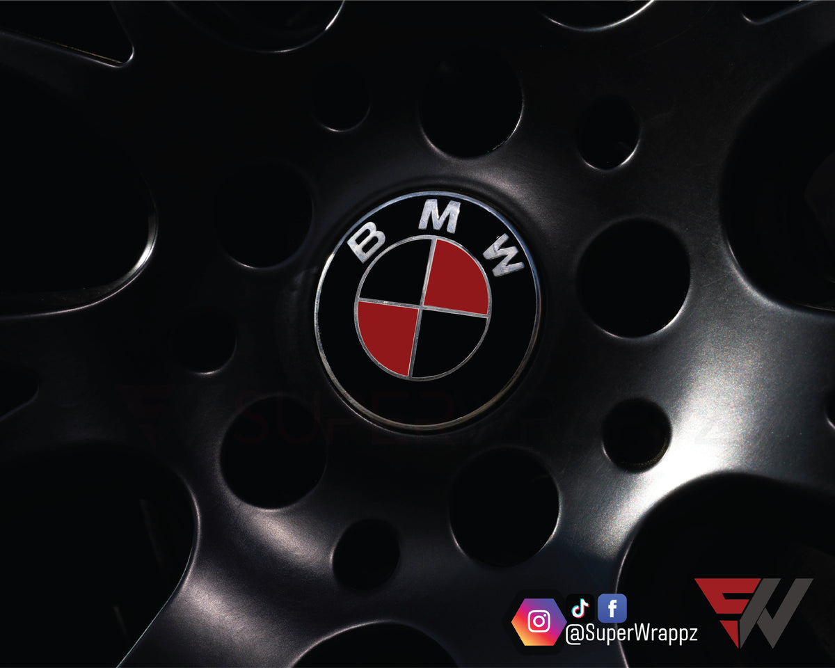 Black & Red Metal Gloss BMW badge overlay applied to an alloy wheel centre cap, close-up