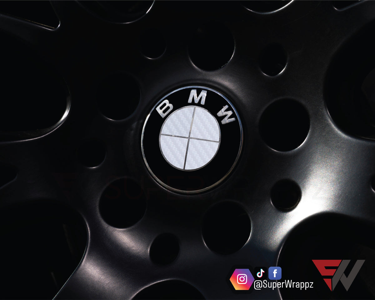 Full White Carbon BMW badge overlay applied to the front hood badge, close-up