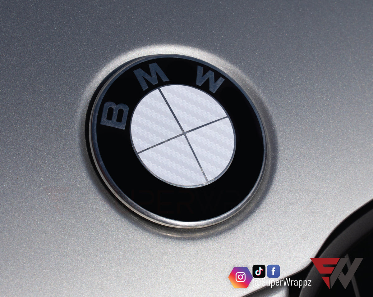 Full White Carbon BMW badge overlay applied to an alloy wheel centre cap, close-up