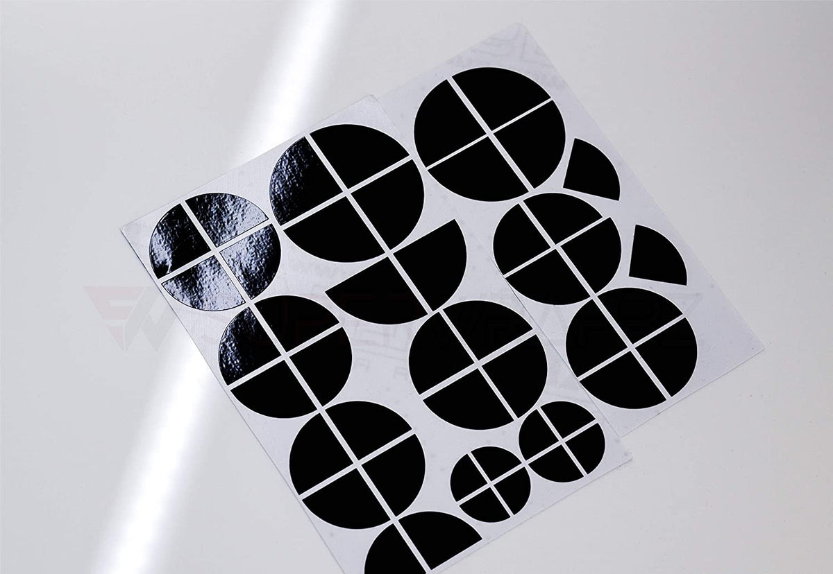 Full Black Gloss BMW badge overlay, shown uncut on its adhesive backing sheet before application