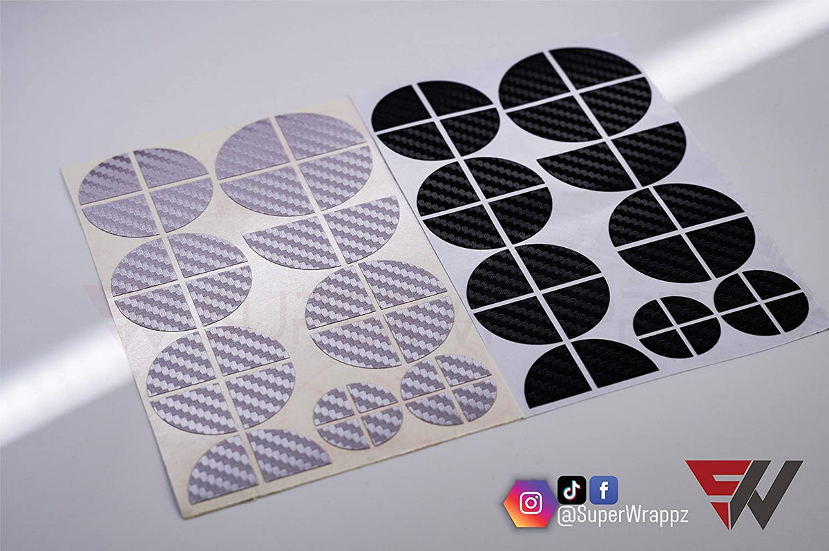 Black & Silver Carbon BMW badge overlay, shown uncut on its adhesive backing sheet before application