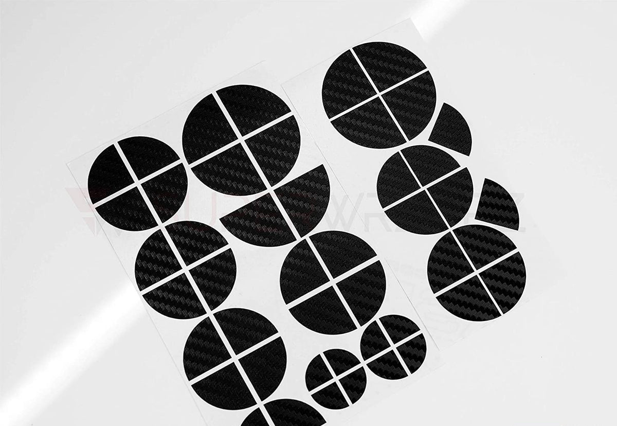 Full Black Carbon BMW badge overlay, shown uncut on its adhesive backing sheet before application