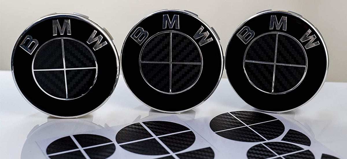 Full Black Carbon BMW badge overlay, complete badge set laid out on a plain background