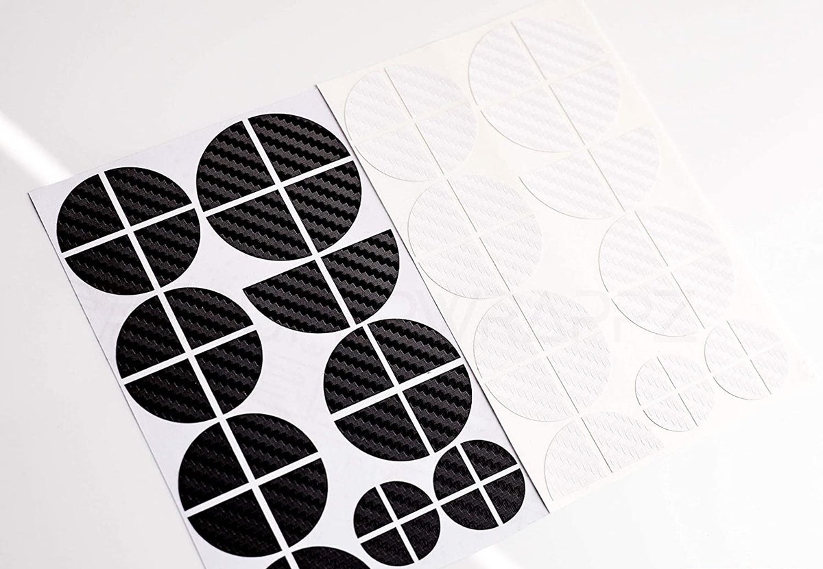 Black & White Carbon BMW badge overlay, shown uncut on its adhesive backing sheet before application