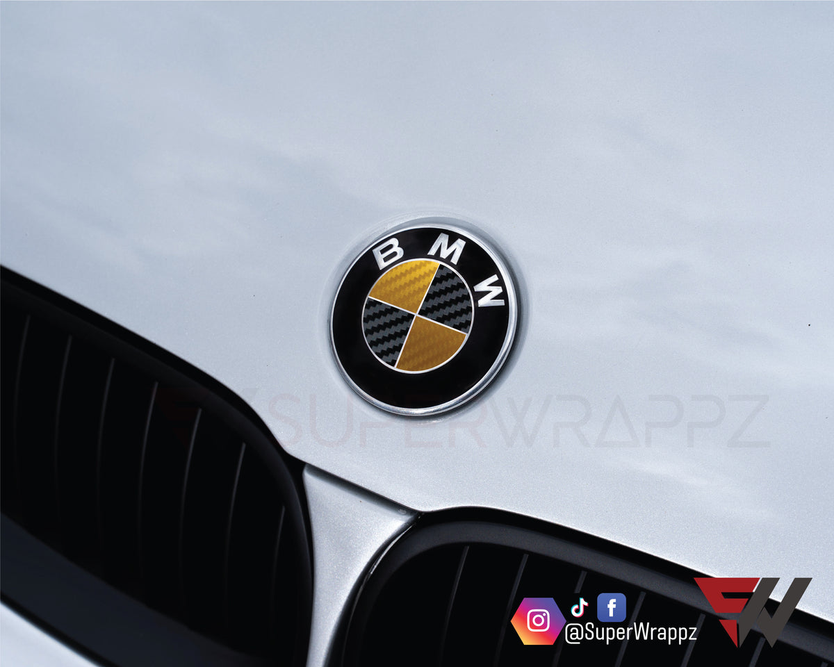 Black & Gold Carbon BMW badge overlay applied to the front hood badge, close-up