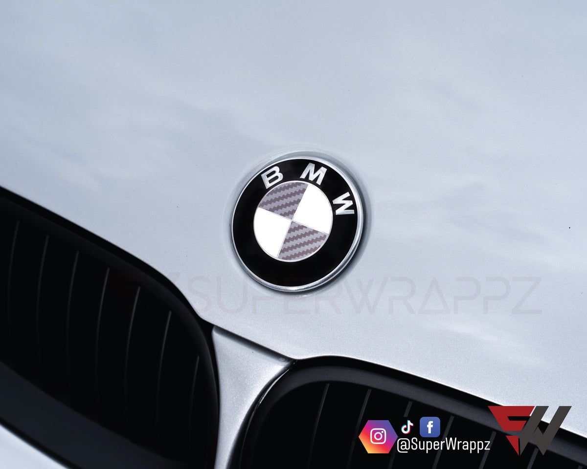 Half Silver Carbon BMW badge overlay on the front hood badge, close-up