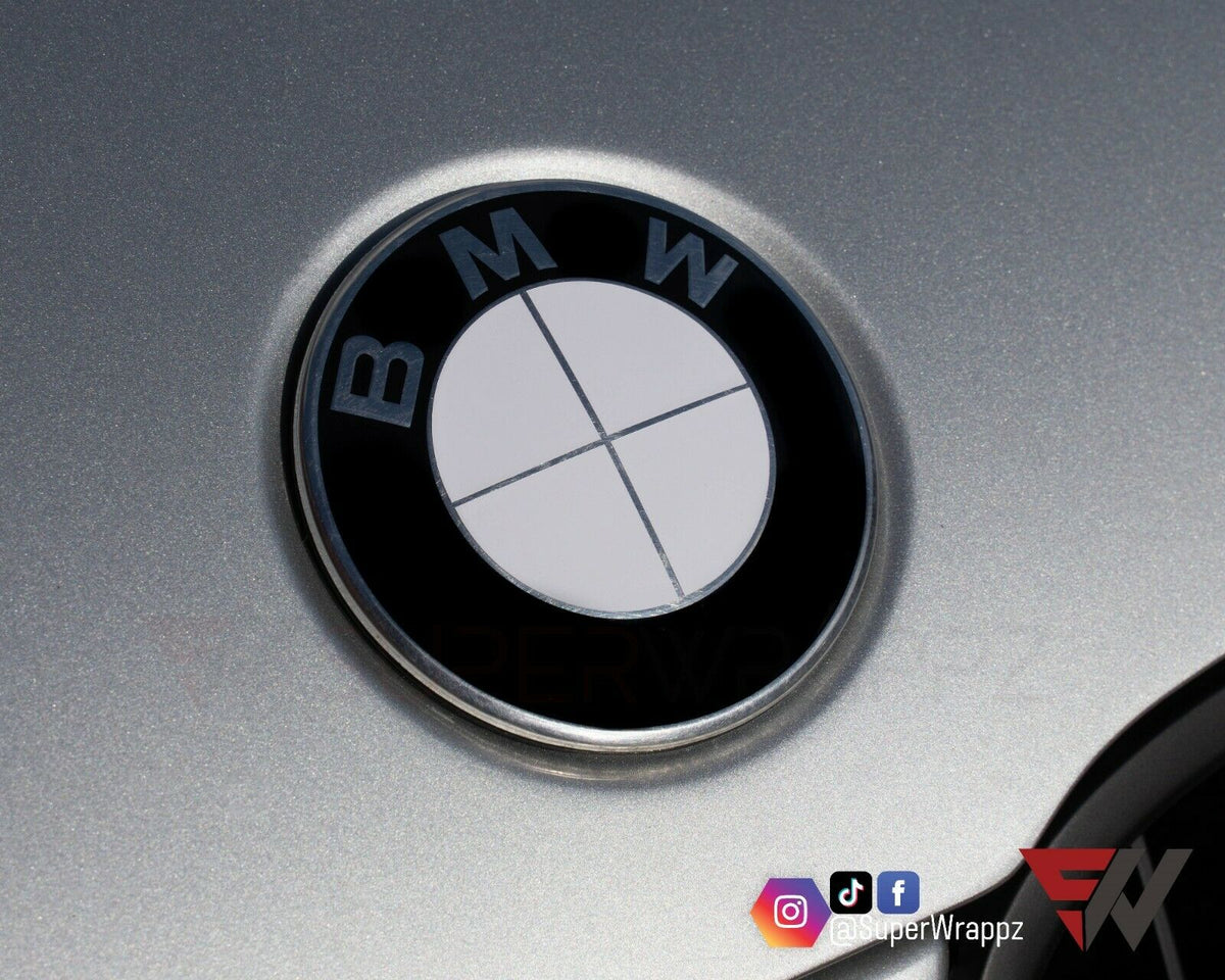 Full White Gloss BMW badge overlay applied to the front hood badge, close-up