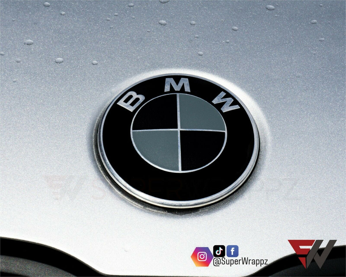 Black & Dark Grey Matte BMW badge overlay applied to the front hood badge, close-up